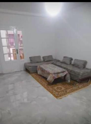 a living room with a couch and a table at صلامندر in La Salamandre