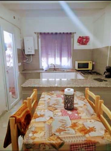 a kitchen with a table and chairs and a table and a kitchen at صلامندر in La Salamandre