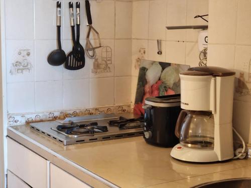 a kitchen counter with a coffee maker on a stove at Buena Vista in San Carlos de Bariloche