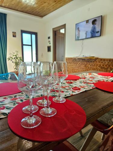 a table with wine glasses on a red table cloth at WoodStar in Ambrolauri
