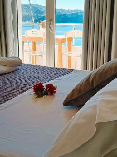 a bed with two roses sitting on top of it at Sea Side Serenity 6 in Himare