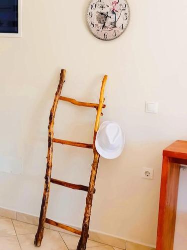 a wooden ladder leaning against a wall with a clock at Sea Side Serenity 6 in Himare
