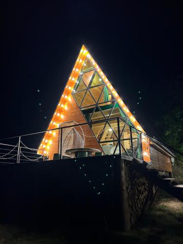 a church with lights on the roof at night at Ramona in Ambrolauri