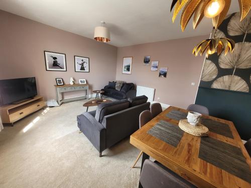 a living room with a couch and a table at Grove Place - 2 Bedroom apartment Leamington Spa in Leamington Spa