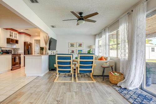 a kitchen with two blue chairs and a table at Pool and Game Room Family-Friendly Stuart Oasis! in Stuart