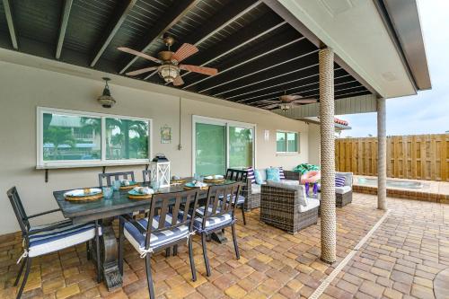 a patio with a table and chairs and a ceiling at Waterfront Fort Myers Home Private Pool and Dock in Fort Myers