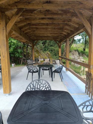 a patio with a table and chairs in a pavilion at Belaustegi turismo rural in Ispáster