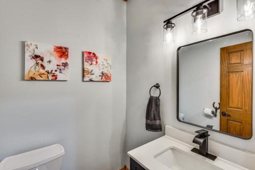 a bathroom with a sink and a mirror at Huge Family Home with Pool - 13 Mi to Lake Michigan! in LaPorte