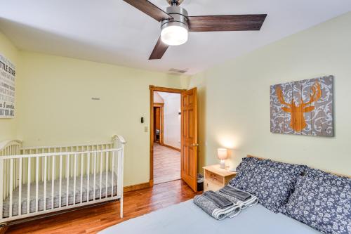 a bedroom with a crib and a ceiling fan at Huge Family Home with Pool - 13 Mi to Lake Michigan! in LaPorte