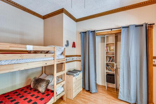 a bedroom with two bunk beds with blue curtains at Huge Family Home with Pool - 13 Mi to Lake Michigan! in LaPorte