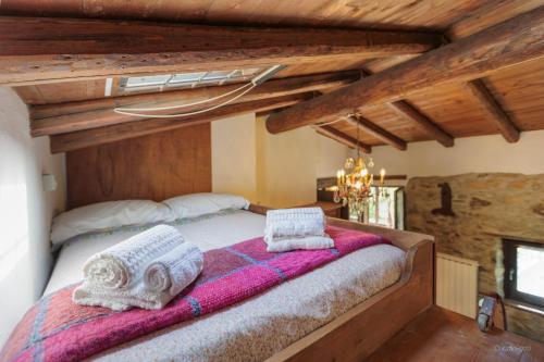 a bedroom with a bed with towels on it at Antico Mulino Baderem in Sorisole