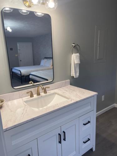 a bathroom with a sink and a large mirror at Moon River Marina & Resort in Cadiz