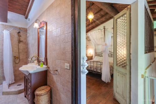 a bathroom with a sink and a bedroom with a bed at Antico Mulino Baderem in Sorisole