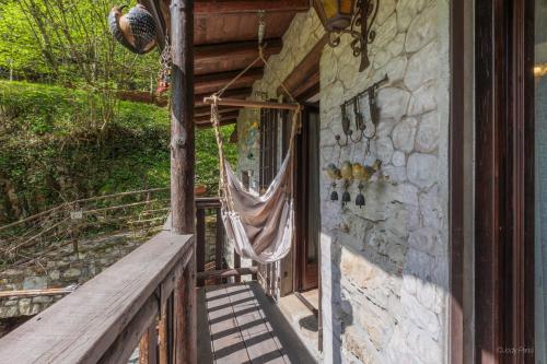 a porch of a house with a hammock on it at Antico Mulino Baderem in Sorisole