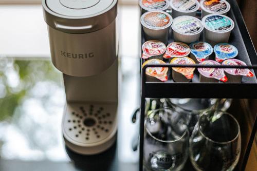 a keurig coffee machine with cups on a shelf at The Historic Inn at Oakdene in Staunton