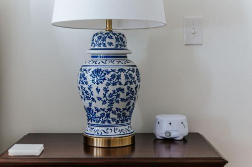 a blue and white vase sitting on a table with a lamp at The Historic Inn at Oakdene in Staunton