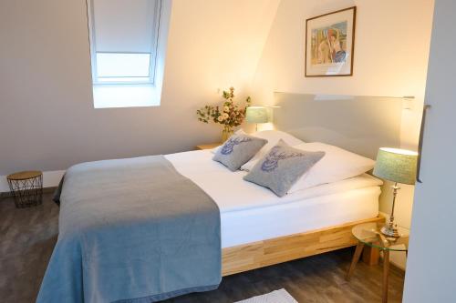 a bedroom with a large white bed with two pillows at Haus Burgsponheim in Burgsponheim
