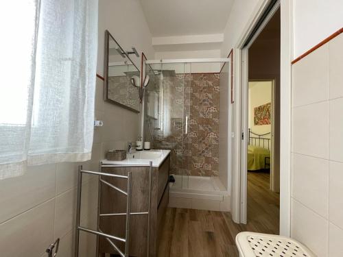 a bathroom with a sink and a shower at Suite de la Sicilienne in Castellammare del Golfo