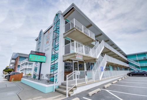 a building with white stairs in a parking lot at Surf Inn Suites in Ocean City