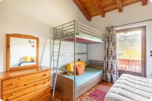 a bedroom with a bunk bed and a mirror at La maison rose in Brissogne