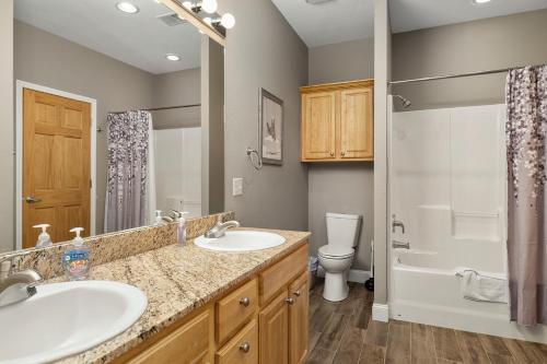 a bathroom with two sinks and a toilet at Condo #353 in Branson