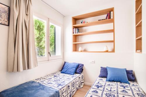2 camas en una habitación con ventana en Pianc, en Cadaqués