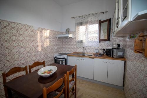 a kitchen with a table and a dining room at Harrys bar & apartments in Acharavi