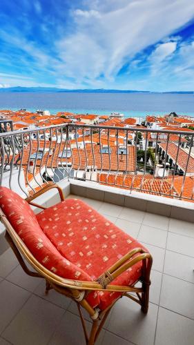 a bench on a balcony with a view of the ocean at Rona Vista Suites amazing seaview 2 in Polykhrono