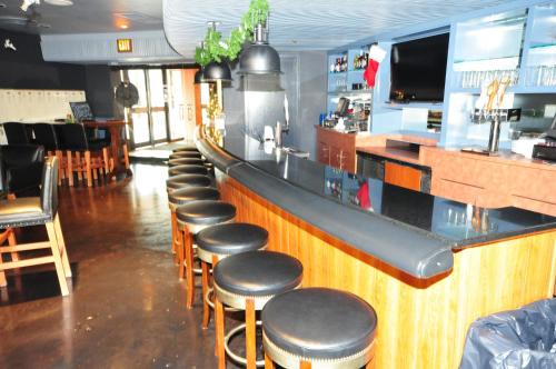 a bar with a row of stools in a restaurant at Radisson Hotel Duluth-Harborview in Duluth