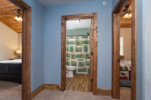 a bathroom with a toilet and a mirror at Lodge 17 in Branson
