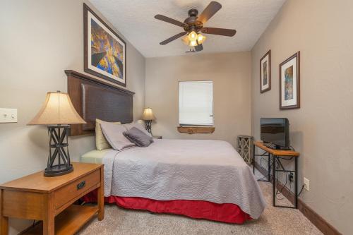 a bedroom with a bed and a ceiling fan at Lodge 17 in Branson