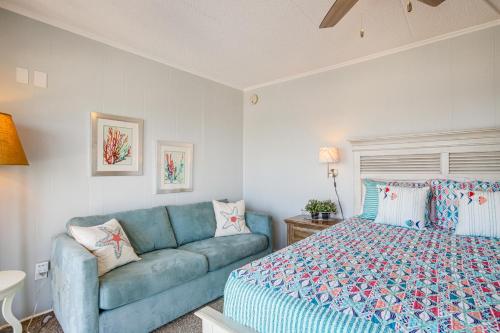 a bedroom with a blue couch and a bed at Heated Pool and Views Beachfront Ocean City Gem in Ocean City
