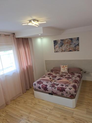 a bedroom with a bed and a window at Sweet dreams in Alicante