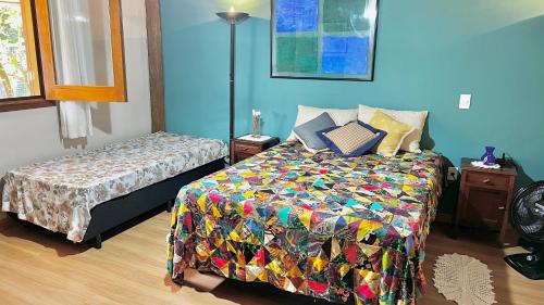 a bedroom with a bed with a colorful quilt at Suite de casa de campo in Socorro