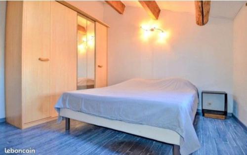 a bedroom with a bed in a room at Agréable maison de village in Laudun
