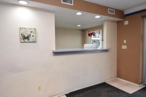 a waiting room with a butterfly picture on the wall at University Manor Inn in Buffalo