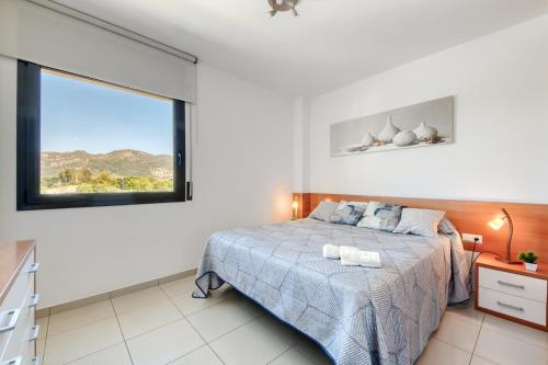 a bedroom with a bed and a large window at Mileni 2 1 3 1 Roses - Immo Barneda in Roses