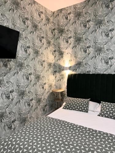 a bedroom with a bed and a wall mural at Costantino Home in Pompei
