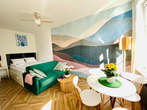 a living room with a green couch and a table at Ogarna 33 studios in Gdańsk