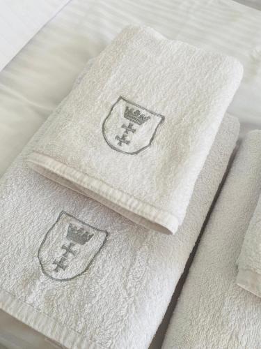 two towels sitting on top of a bed at Ogarna 33 studios in Gdańsk