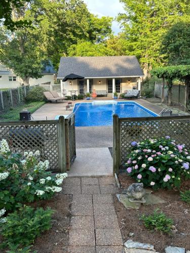 a house with a fence and a swimming pool at Pool House in Clarksdale