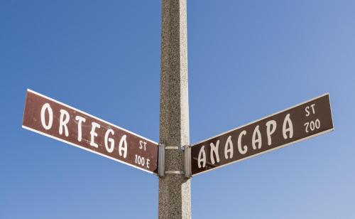 dos letreros de la calle en un poste con un cielo azul en The Inn At Anatega #2 en Santa Bárbara