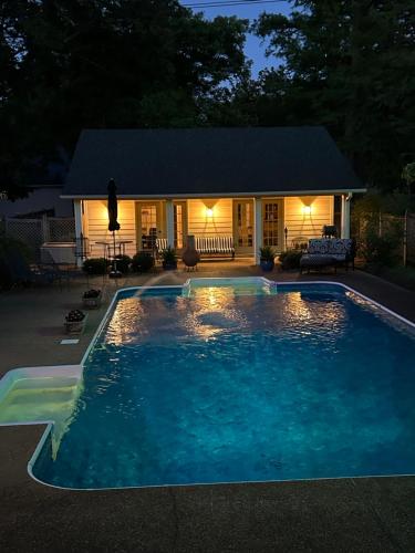 a swimming pool in front of a house at night at Pool House in Clarksdale