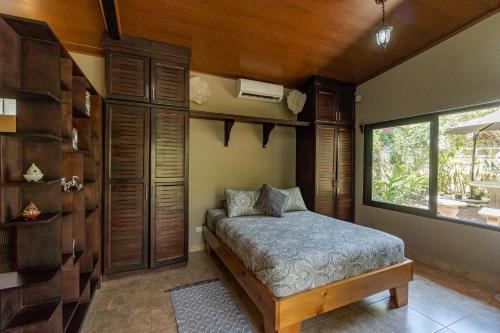 a bedroom with a bed and a window at Casa Cabo Blanco Mal Pais in Carmen