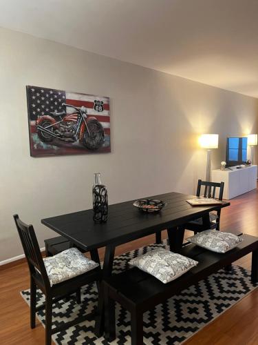 une salle à manger avec une table avec des chaises et un tableau de moto dans l'établissement Capitole - Centre ville, à Toulouse