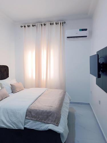 Ένα ή περισσότερα κρεβάτια σε δωμάτιο στο blueocean.cog Apartments