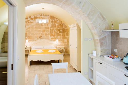 a bedroom with a bed and a table in a room at La Perla del Mare in Monopoli