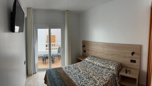 Posteľ alebo postele v izbe v ubytovaní Hostal Juan Carlos