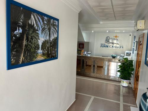 a hallway with a wall with a picture on the wall at Hostal Juan Carlos in Carboneras