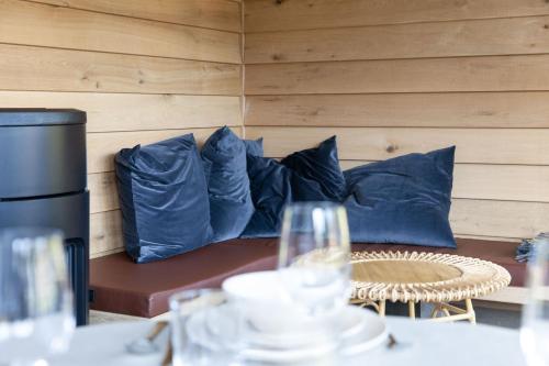a couch with blue pillows in a room at The Funny Friends in Gedinne